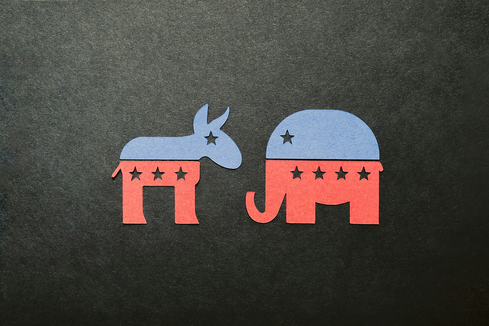 Blue and red paper cutouts of a donkey and elephant with stars on a dark background, symbolizing political parties.