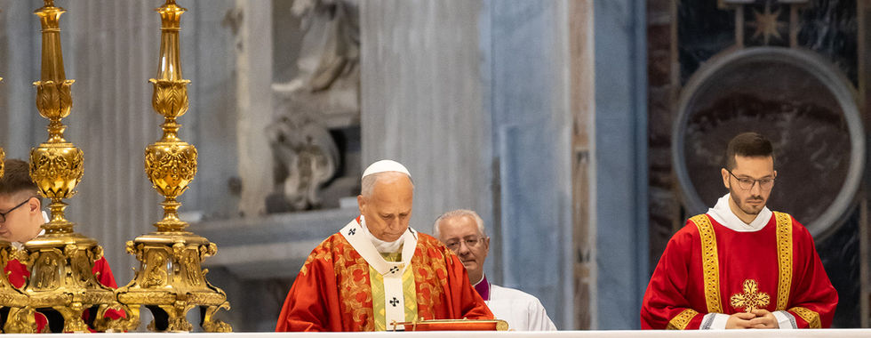 Pope and altar servers in red vestments stand at a decorated church altar with gold candlesticks during a solemn Mass.
