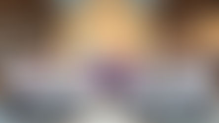 Group photo in a church with clergy, altar servers in white robes, and boys in red jackets. Iconic mural and crosses in the background.