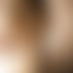 Outstretched hand in a flowing, cream-colored robe, reaching forward in soft lighting. Background is blurred, creating a serene atmosphere.