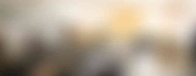 Empty classroom with arranged desks and chairs, colorful bottles, American flag, and text on wall: "The heavens declare..." Bright, tidy setting.
