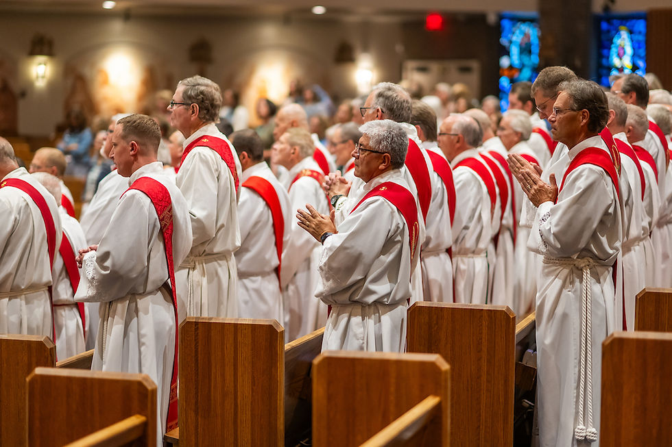 Clergy in white robes with red stoles stand and pray in a church setting, surrounded by wooden pews and stained glass. Peaceful atmosphere.