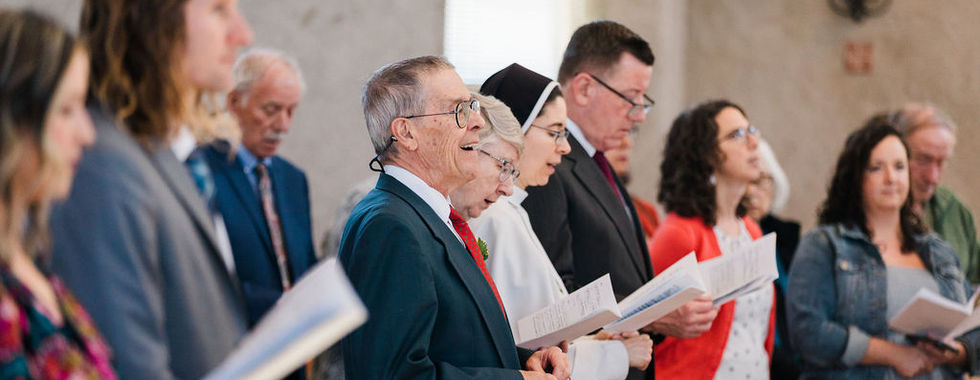 Members of the congregation and religious sisters sing and pray together during a solemn Mass celebrating religious vows.