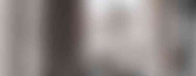 A crowd in winter coats gathers on a snowy day between tall columns. A cross is visible. Red pedestrian light shows a hand with number 8.