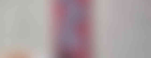 A red banner reading “In the face of evil we stand” is visible through heavy snowfall at the rally.