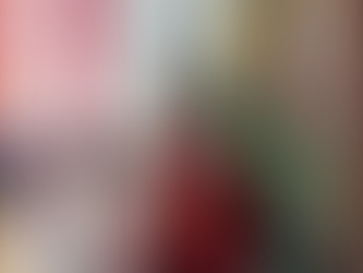 Children in traditional attire perform in a church. Girl in green and red, boy in sombrero. Candles, flowers, and statue in the background.