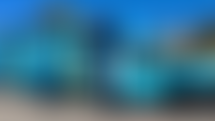 Blue mobile medical van labeled "Marisol Health" with ultrasound, parked outdoors on a sunny day. Stairs lead to an open side door.