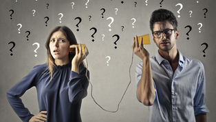 A confused man and woman use tin can phones; question marks fill the gray background, suggesting misunderstanding.