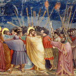 A dramatic scene with a group of people holding torches. A man in a golden robe is embraced. The night sky is in the background.