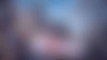 A group holds a Colorado March for Life banner outside a domed building, with trees and a U.S. flag in the background. Sunny day.