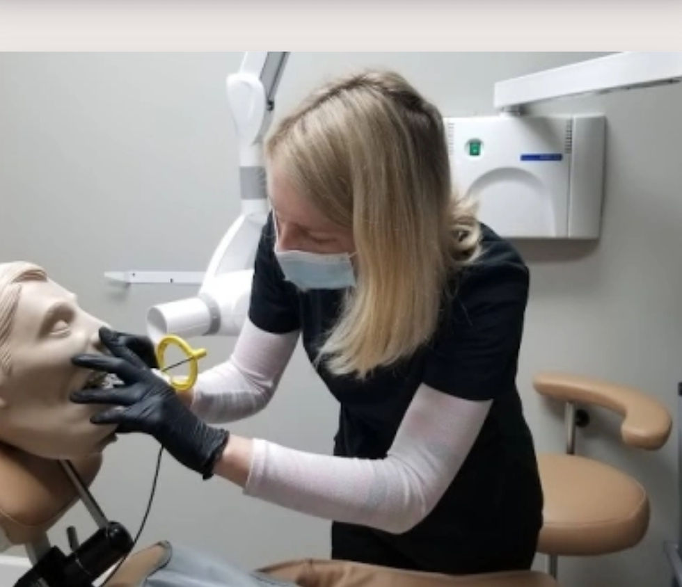 A dental student practices techniques on a mannequin in a hands-on learning environment, enhancing skills through practical training.