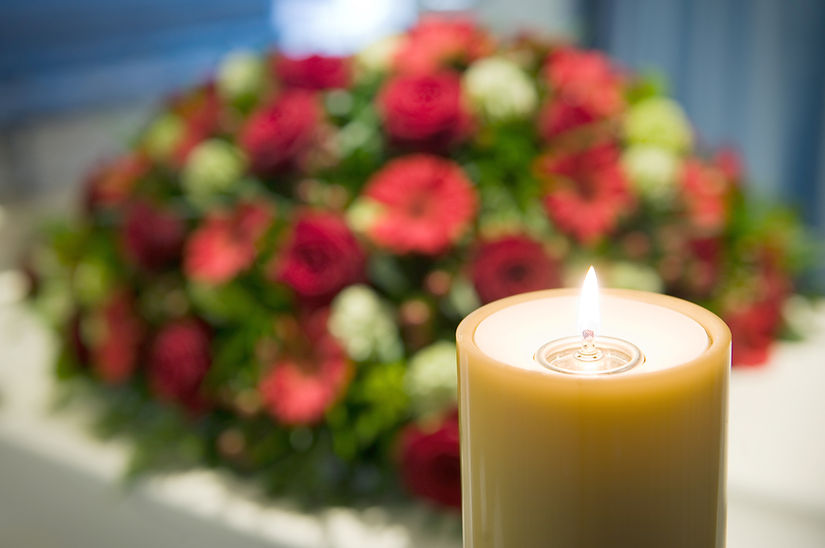 Funeral flowers and candle