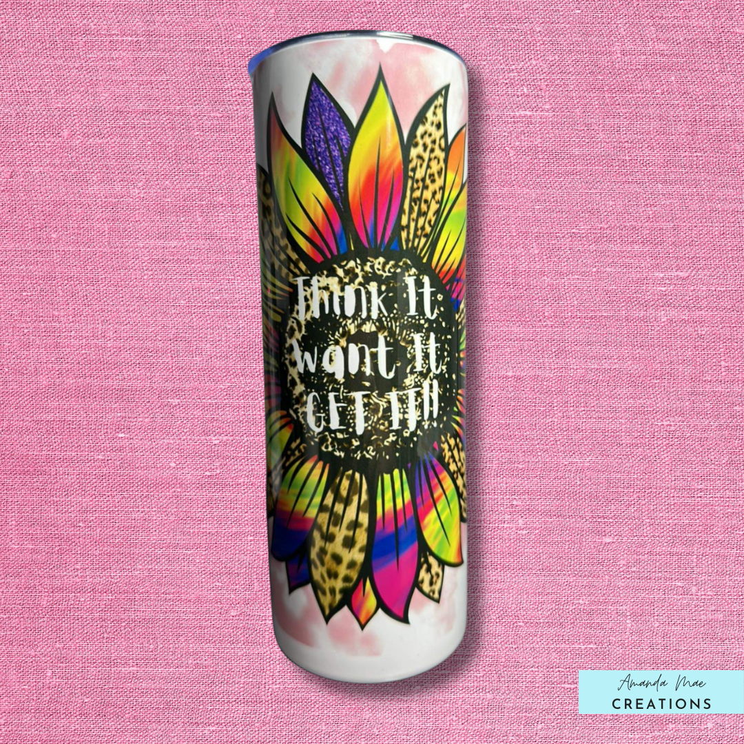 20 oz tumbler with a bright multi-coloured sunflower that reads think it, want it, get it in the middle 