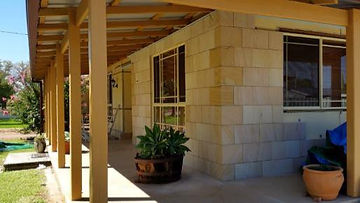 Lightweight sandstone wall cladding veneer over an old fibro house exterior with energy saving insulation