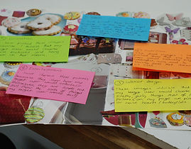 Image: Note cards of multiple colors, layed out over a magazine