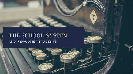 an old type writer and text says the school system and newcomer students