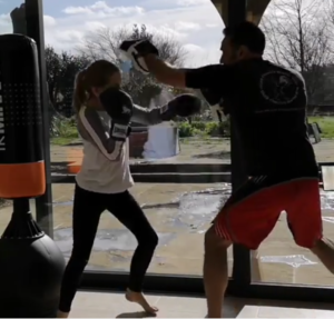 student coaching punching focus mitt pad