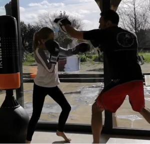 student coaching punching focus mitt pad