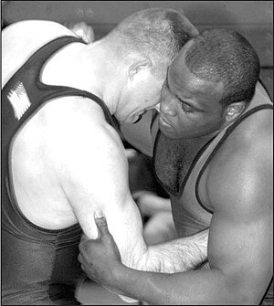 Two wrestlers in a clinch, using over- and und...