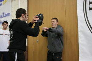 Jamie Clubb coaches a transitional striking drill, beginning with the fence