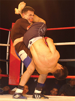 The standing fighter is attempting to escape d...