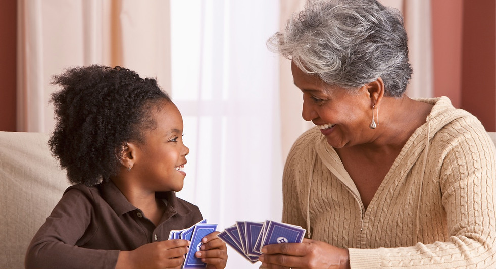 One Adult and one child playin cards Carolina Speech and Neuro Rehab Asheville Speech Therapy
