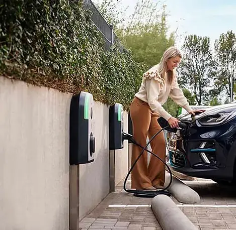 EVlink_Pro schneider apartment charger with woman plugging into car