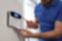 Image of a man with a screwdriver opening an alarm interface