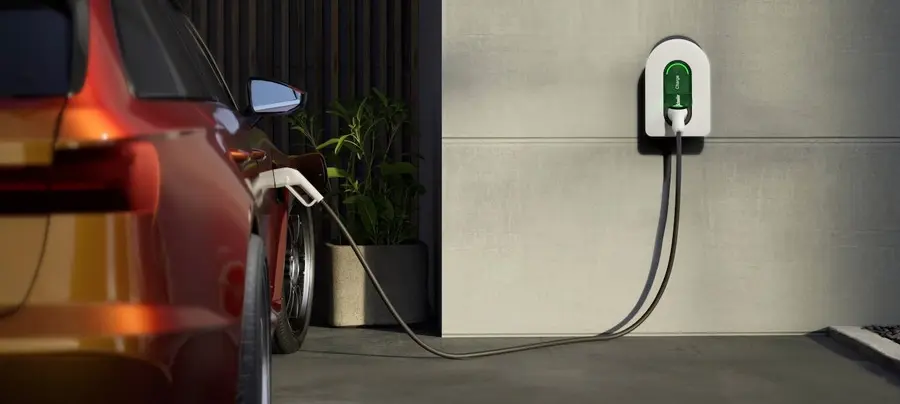 Schneider electric charger on concrete wall charging orange car