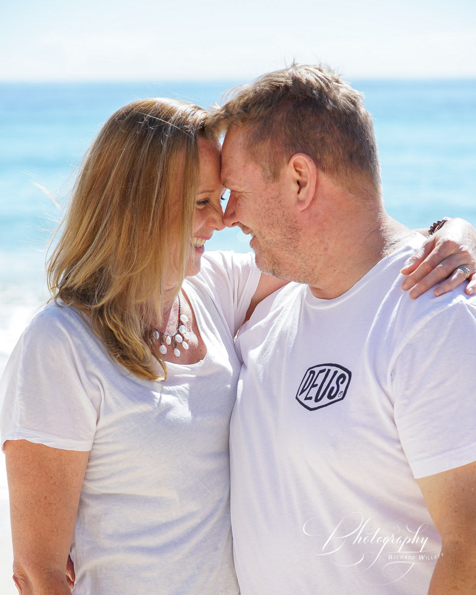 Couple touching foreheads together at the beach