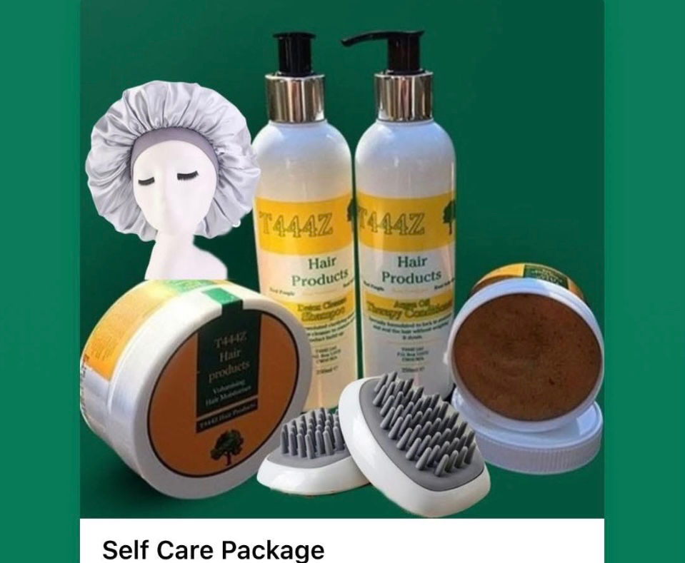 Eye-level view of hairbrush and natural hair care products on wooden surface
