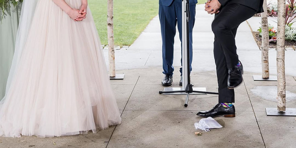 jewish wedding tradition of breaking the glass by groom stomping on the glass inside a cloth pouch