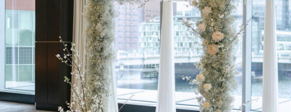 Beautifully decorated chuppah with baby's breath and greenery