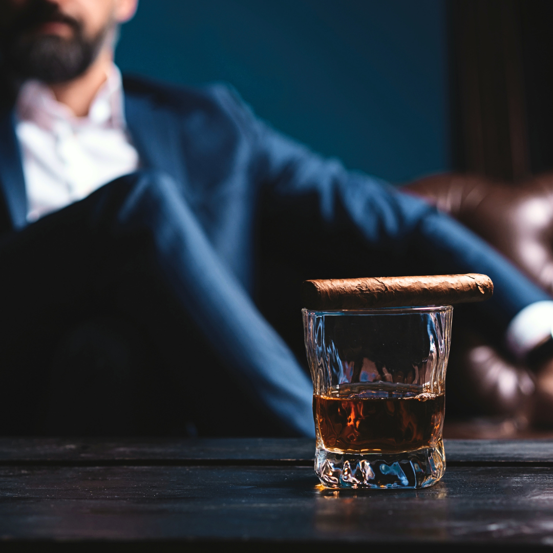 sophisticated man with glass of whiskey