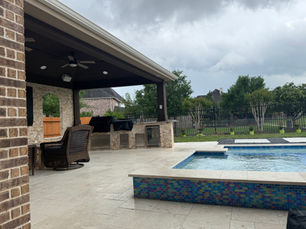 covered patio with outdoor kitchen and granite countertop