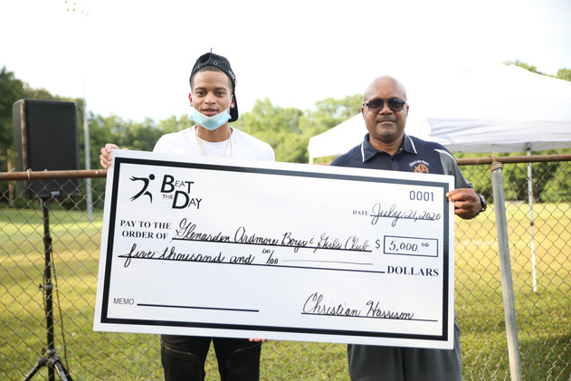 Coach Barry, president of the Glenarden Boys and Girls Clubs accepts $5,000 donation.