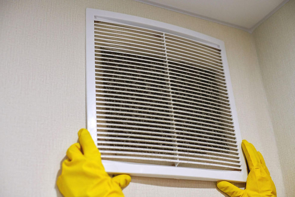 Technician’s hands detaching an HVAC vent cover to begin a thorough air duct cleaning service