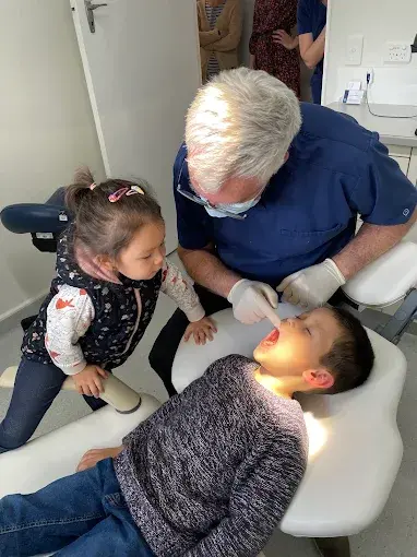 Angie helping Dr John check Tony
