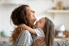 Close up side view overjoyed smiling young mother and daughter hugging and laughing, enjoy
