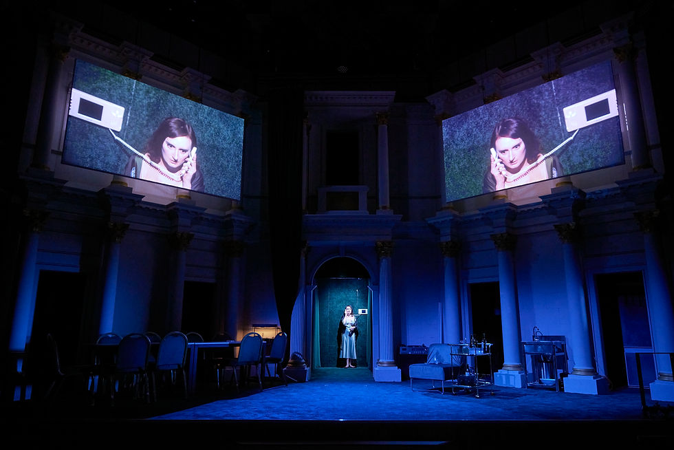 Lady Macbeth on the phone in Shakespeare North Playhouse's production of Macbeth
