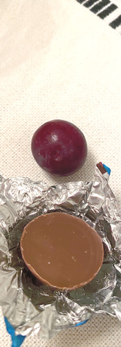 Unwrapped foil chocolate and grape