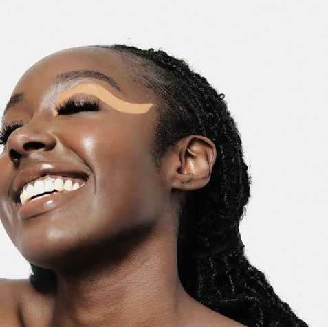 Black model smiling with orange eye makeup 