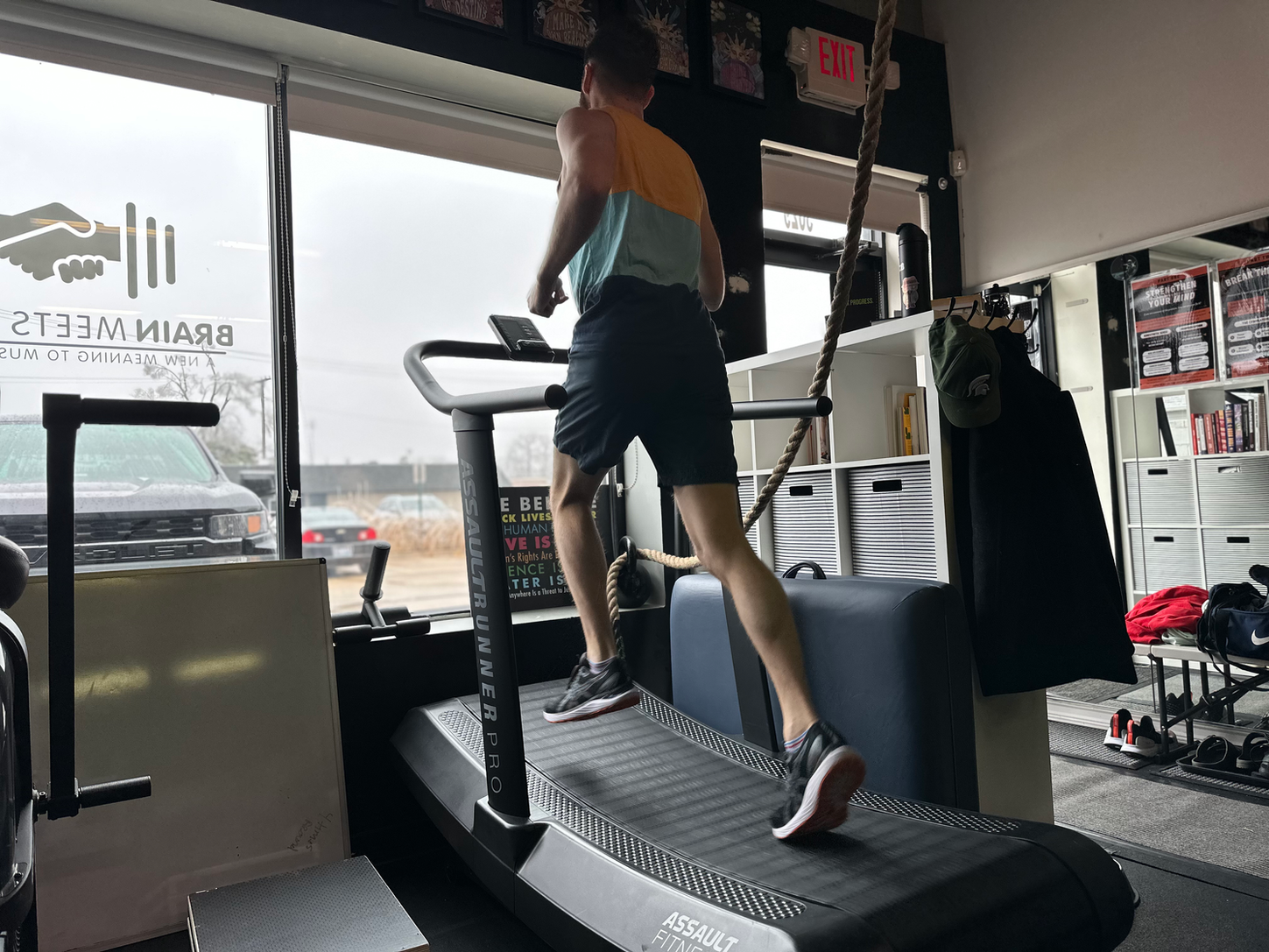 A man running on a treadmill at a private personal training studio.