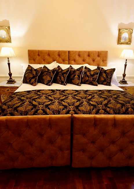 Luxurious bedroom with ornate bed and mirror
