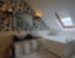 Bathroom: double sinks, floral wallpaper, corner tub, skylight