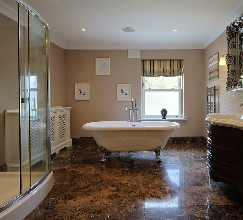 Elegant bathroom with clawfoot tub, shower, and vanity