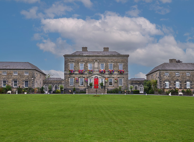 Bellinter House, grand stone manor with red door and green lawn