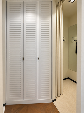 Cream fitting room with louvered cabinet.png