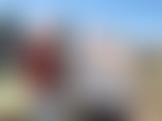 Three people standing with a board advertising the event