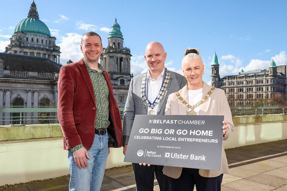 Three people standing with a board advertising the event